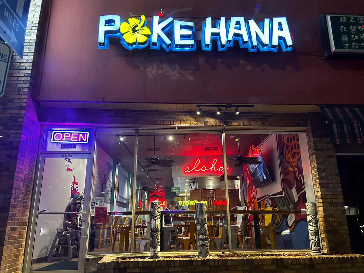 outside poke hana restaurant with bright lights and signage